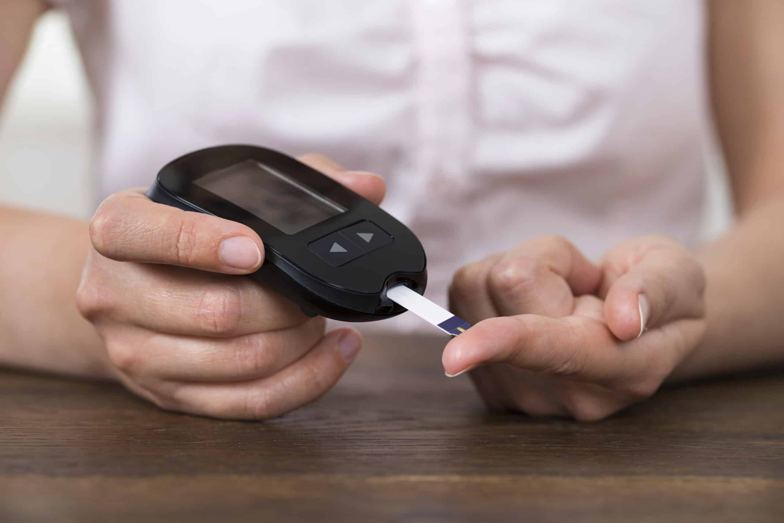 Person Hands Holding Glucometer